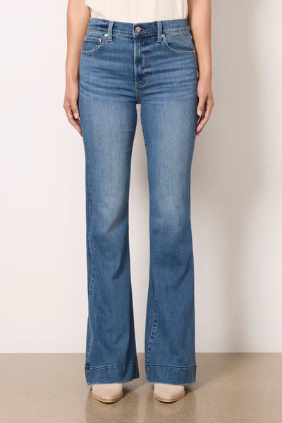 Model wearing Kinsley Flare Jeans in light wash denim, featuring a high-rise fit, flared leg, and vintage-inspired fading