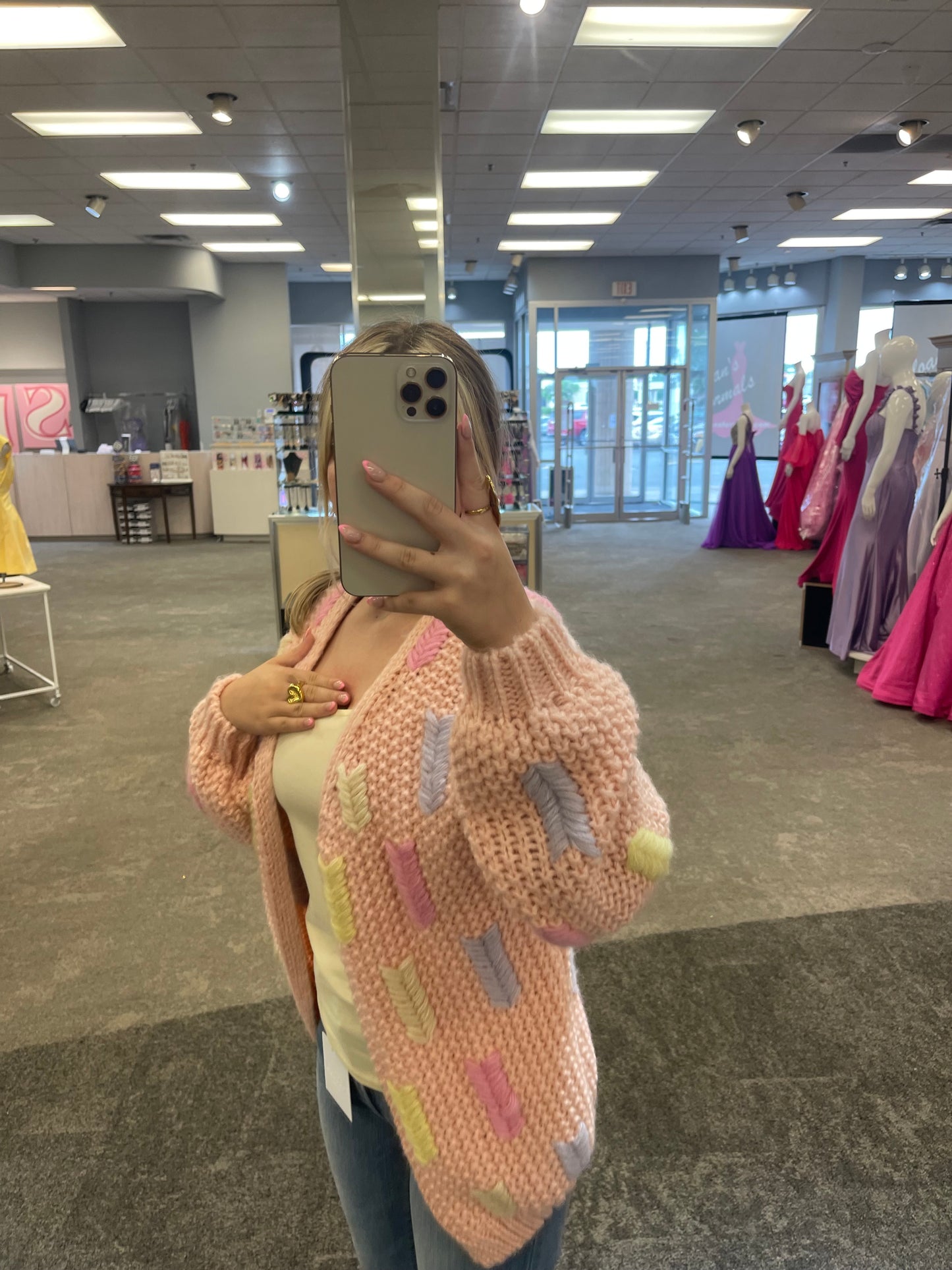 Model wearing the Lobelia Cardigan in rose pale, featuring a relaxed fit, open front, and soft ribbed knit texture.