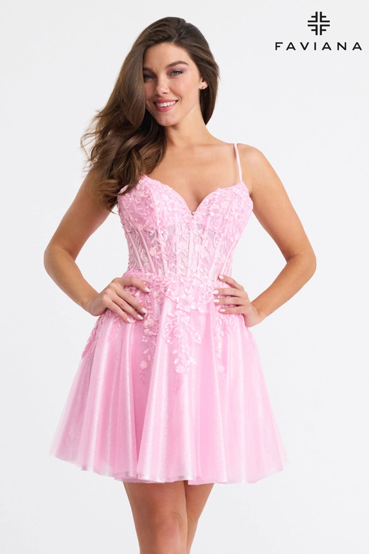 Woman wearing a pink dress with Faviana branding on a white background