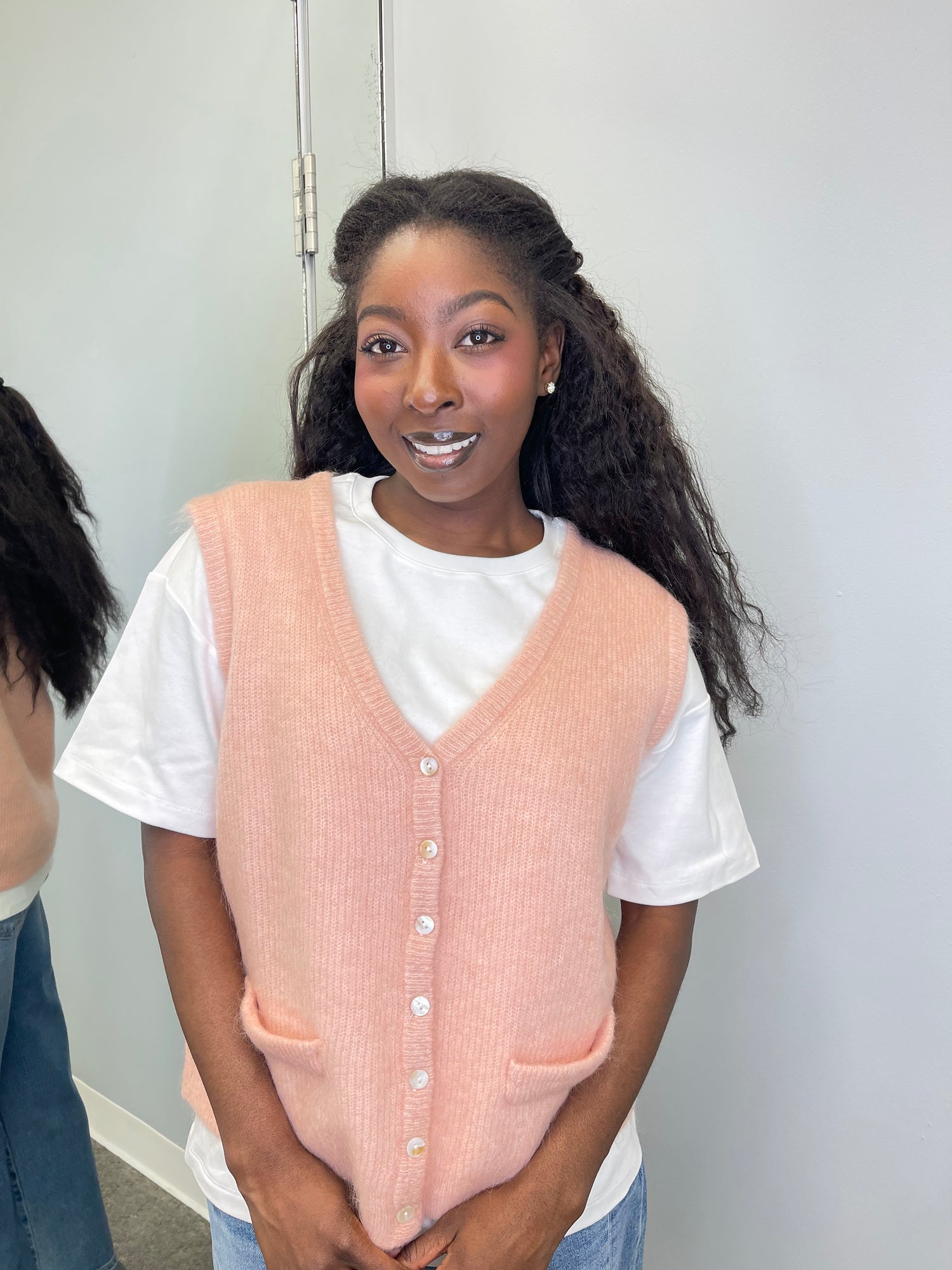 Model wearing the Meliza Cardigan in rose pale, featuring a cropped fit, soft knit texture, and front button closure.