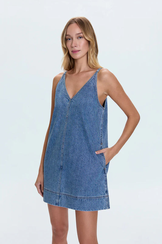Front view of the Tavi Pop Over Dress in Palms with deep V-neckline, side pockets, and spaghetti straps in a casual medium-wash denim finish.