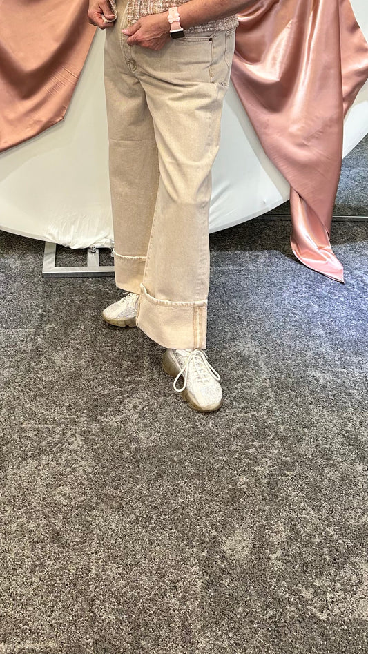 Model wearing the Ryder Cuffed Jeans in tan, featuring a straight-leg fit, cuffed hems, and structured mid-rise waist.