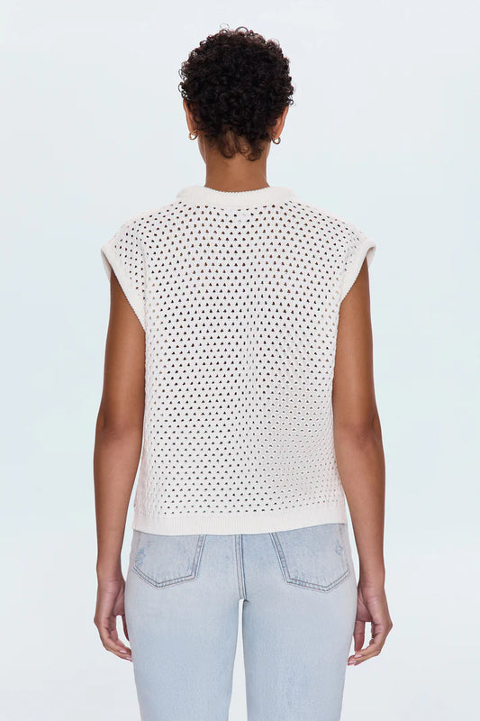 Back view of the Beck Open Knit Cropped Sweater showing full open-knit detailing, ribbed hem, and cap sleeves in a relaxed ivory cotton knit, paired with high-waisted light jeans.